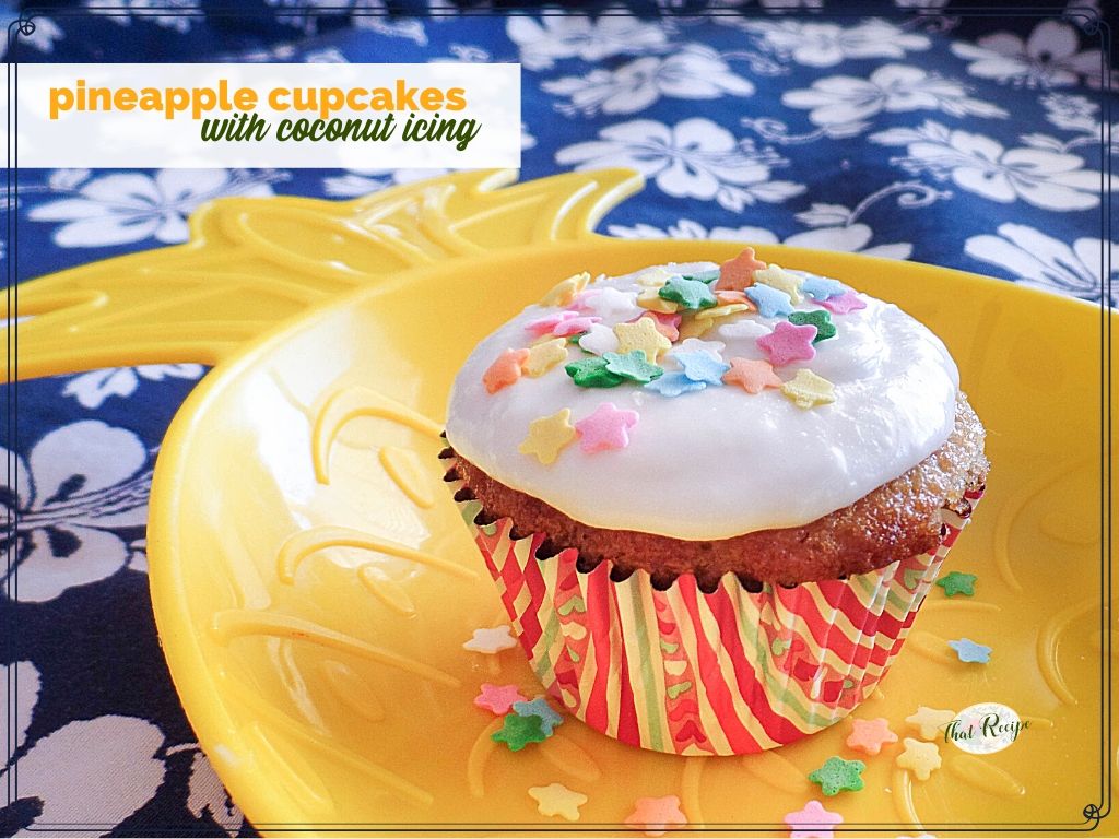 cupcake on a pineapple plate with sprinkles and text overlay "Pineapple cupcakes with coconut icing"