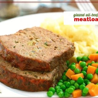 slices of meatloaf on a plate with mashed potatoes and peas and carrots with text overlay "All Beef Glazed Meatloaf"