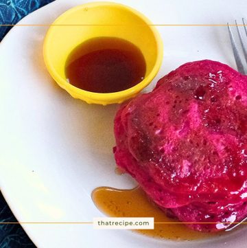 pink pancakes on a plate with syrup