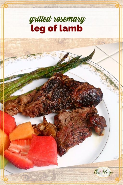 slices of grilled leg of lamb on a plate with asparagus and fresh fruit