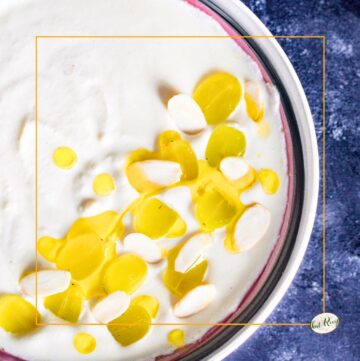 white gazpacho - soup topped with grapes and olive oil in a bowl, ajoblanco