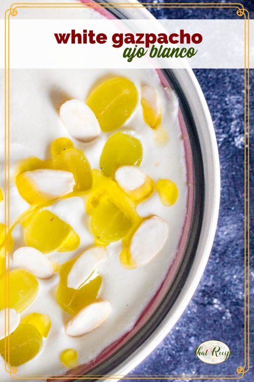 white soup topped with grapes and olive oil in a bowl with text overlay "white gazpacho ajo blanco"