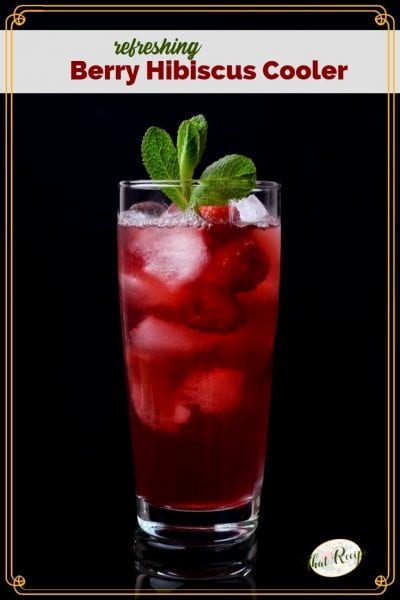 glass of hibiscus tea with raspberries and text overlay "Berry Hibiscus Cooler"