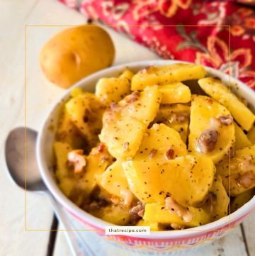 Hot German Potato Salad in a dish (sliced potatoes with creamy bacon sauce)