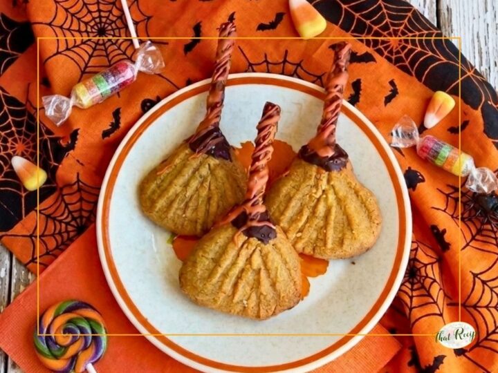 halloween cookies shaped like witch brooms on a plate