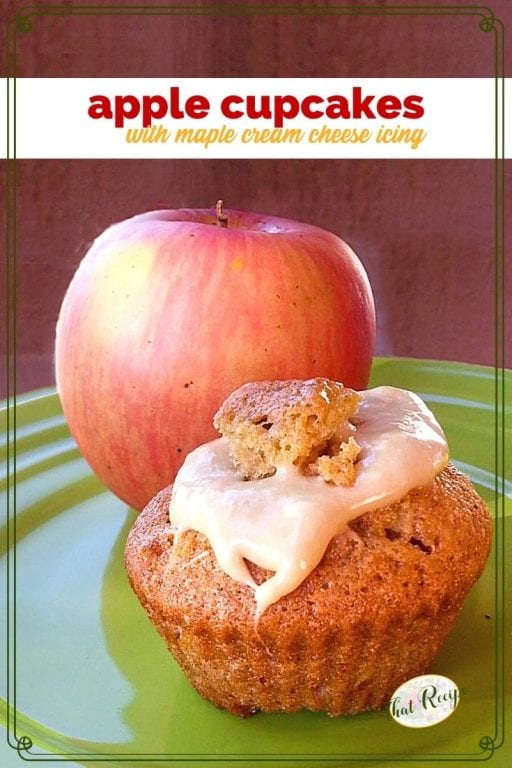 Cupcake on a plate with an apple and text overlay "Apple Cupcakes with Maple Cream Cheese Icing"