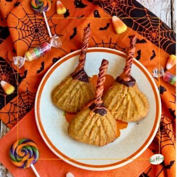 halloween cookies shaped like witch brooms on a plate