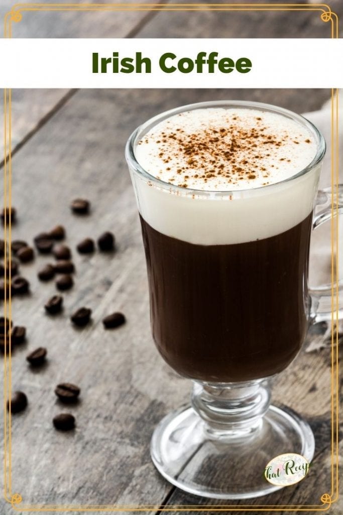 glass mug of Irish Coffee surrounded by coffee beans