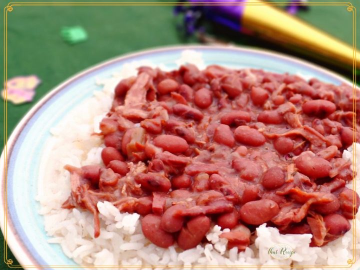 close up of red beans and rice on a plate with mardi gras horn