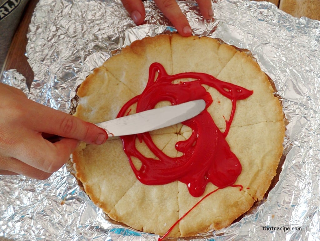 spreading frosting on cookie