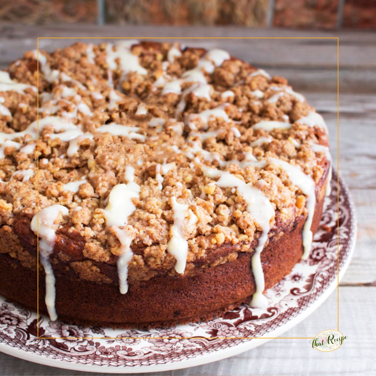 coffee cake with streusel topping and glaze on a plate
