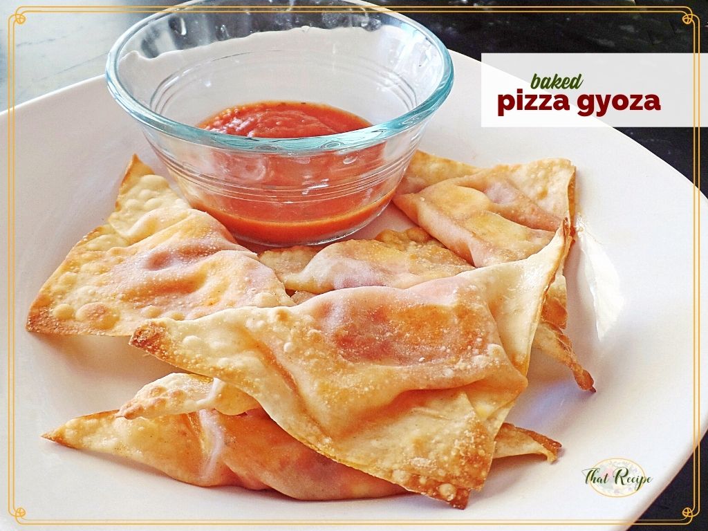 baked wontons on a plate with marinara sauce and text overlay "baked pizza gyoza"