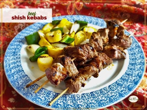 shish kebabs and grilled vegetables on a plate with text overlay "beef shish kebabs"