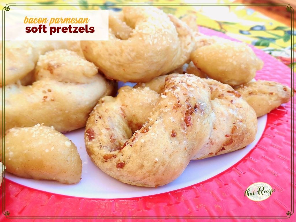 soft pretzels on a plate with text overlay "bacon sourdough soft pretzels"