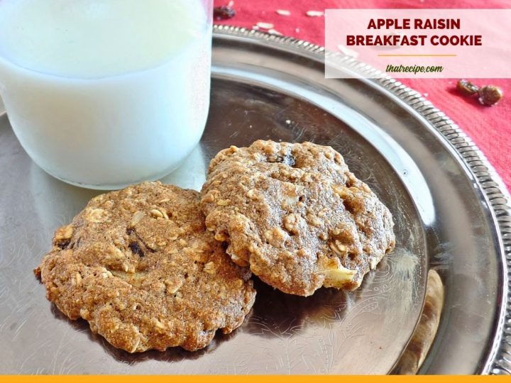 oatmeal cookies with apples and raisins on a tray with milk
