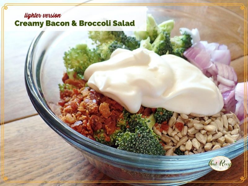 bacon and broccoli salad ingredients in a bowl with text overlay "lighter version creamy bacon and broccoli salad"