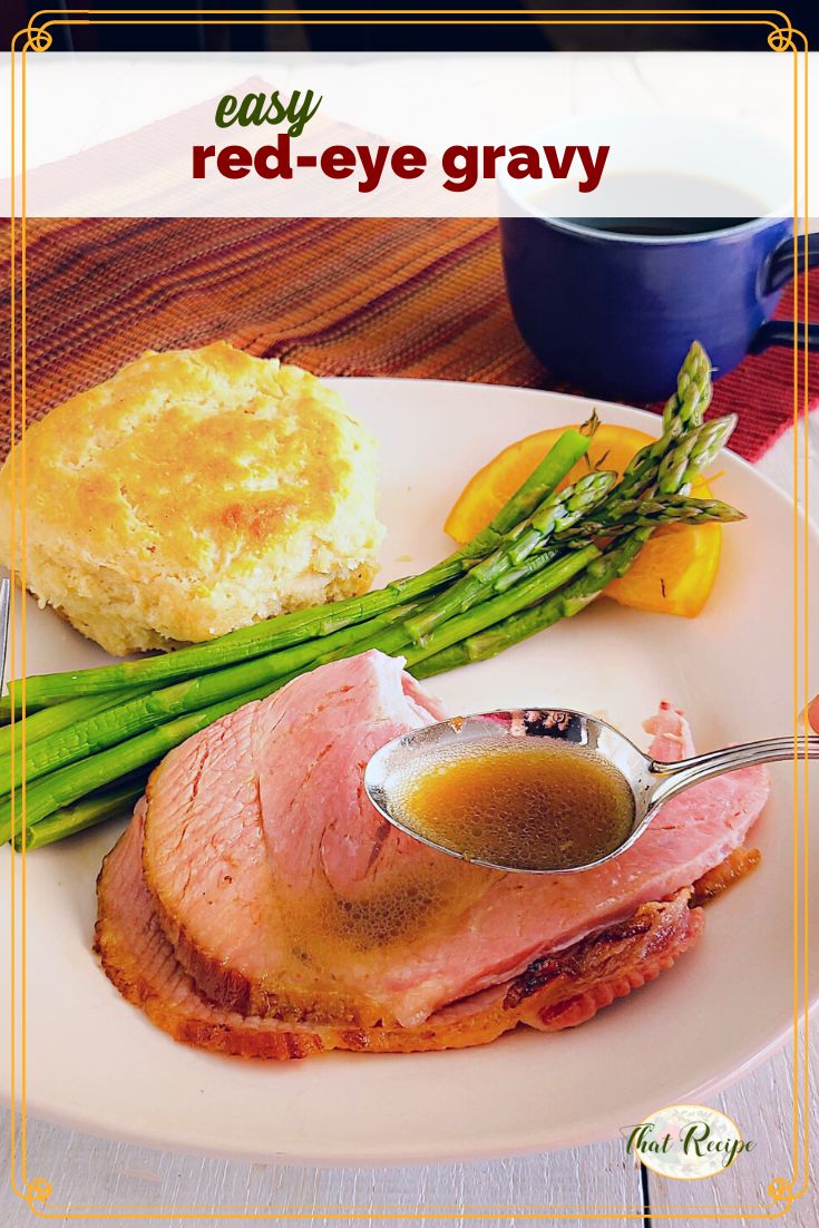 spoon of sauce over plate of ham, asparagus and biscuit with text overlay "easy red eye gravy"