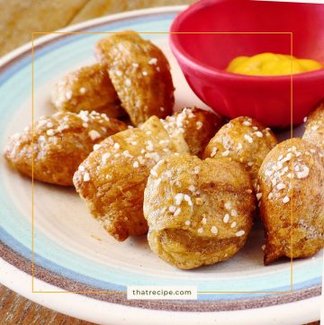 soft pretzel bites on a plate with mustard dip