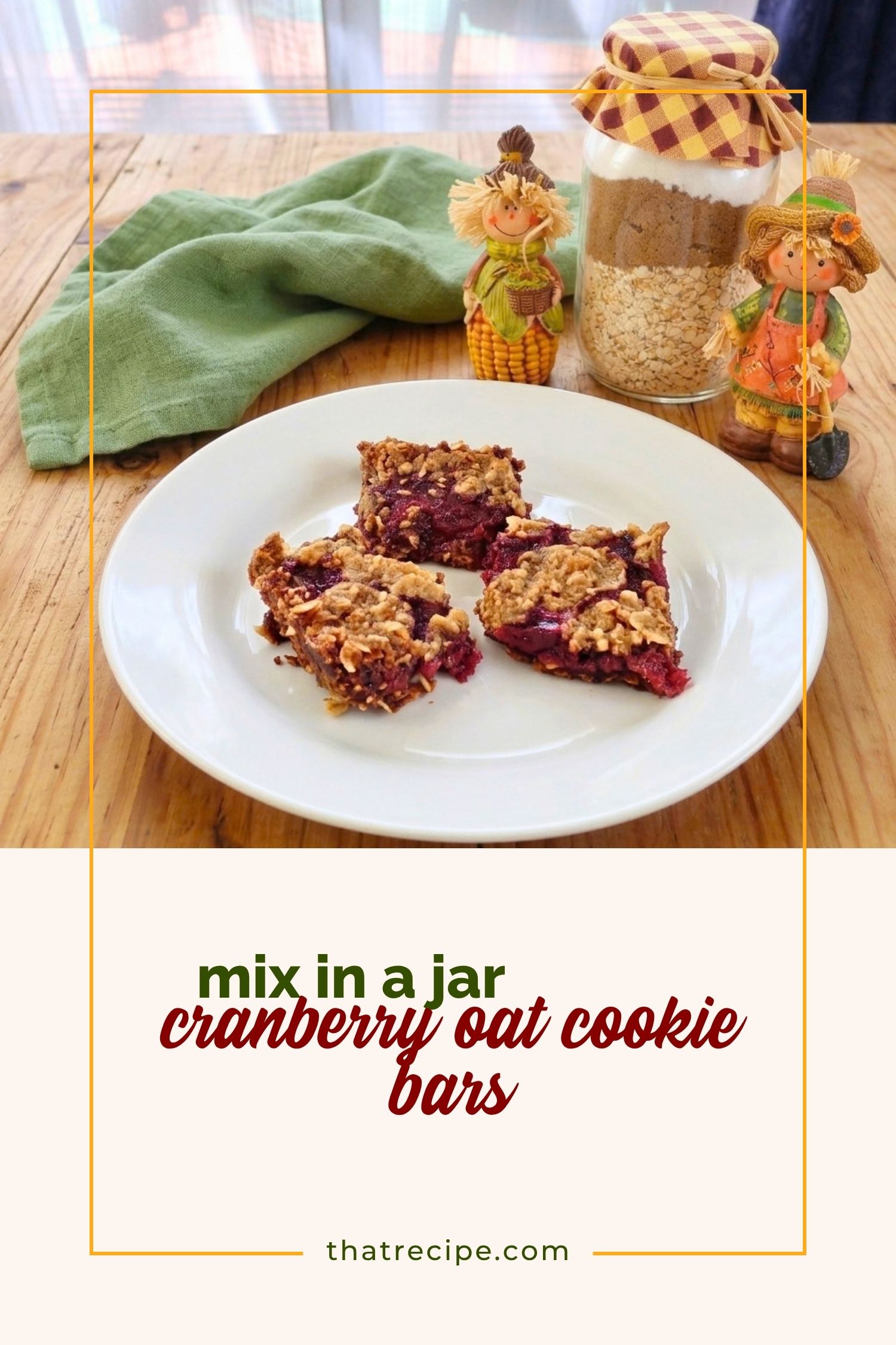 cranberry oat bars on a plate with cookie mix in a jar