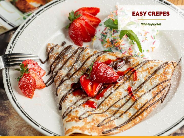 crepe on a plate with chocolate and strawberries on top and text overlay Basic crepes
