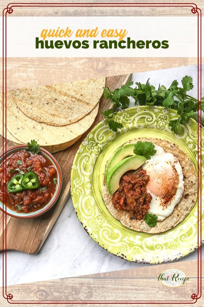 huevos rancheros on a plate with tortillas and a bowl of salsa