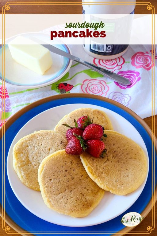 sourdough pancakes on a plate on a table with butter and syrup