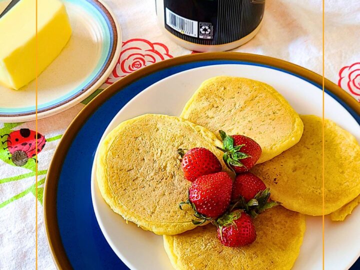 sourdough pancakes on a plate on a table with butter and syrup