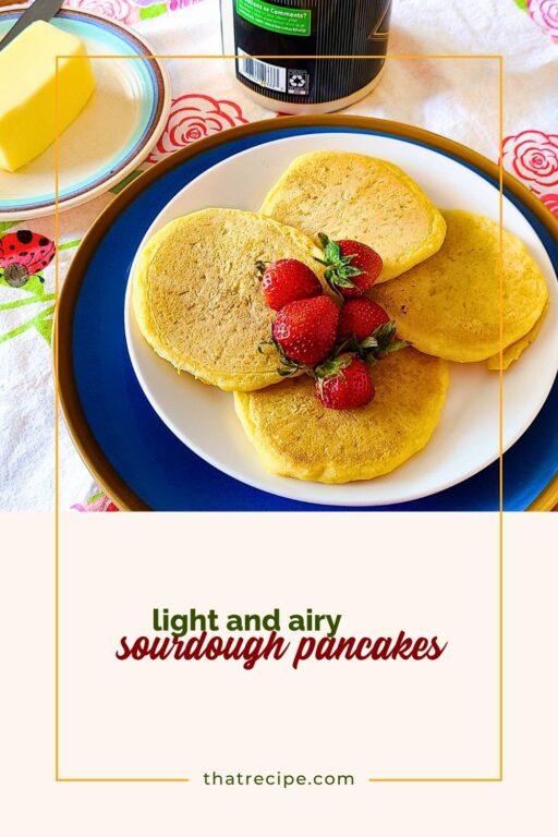 sourdough pancakes on a plate on a table with butter and syrup