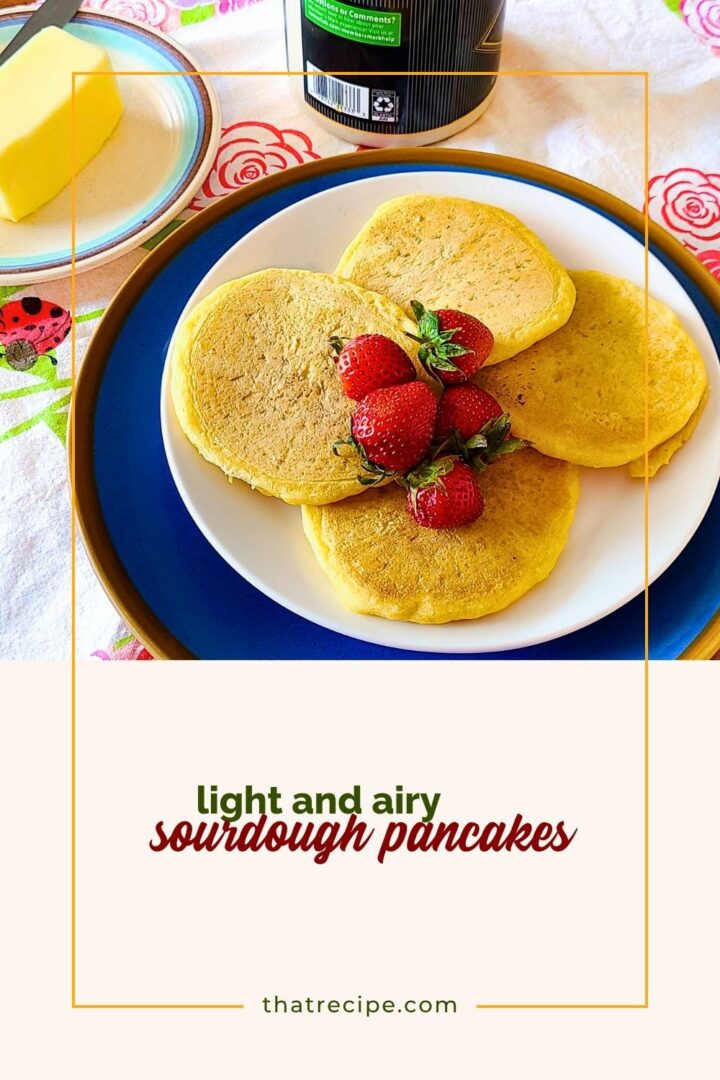 sourdough pancakes on a plate on a table with butter and syrup