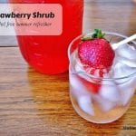 Iced drink with a fresh strawberry on a table