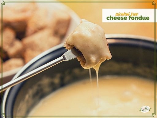 piece of bread dipped in cheese fondue with text overlay "alcohol free cheese fondue"