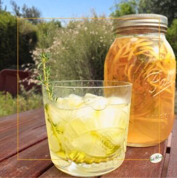 limoncello over ice with mason jar full of homemade limoncello