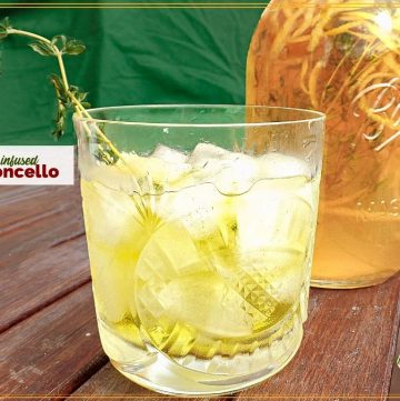 limoncello over ice with mason jar full of homemade limoncello and textoverlay "herb infused limoncello"