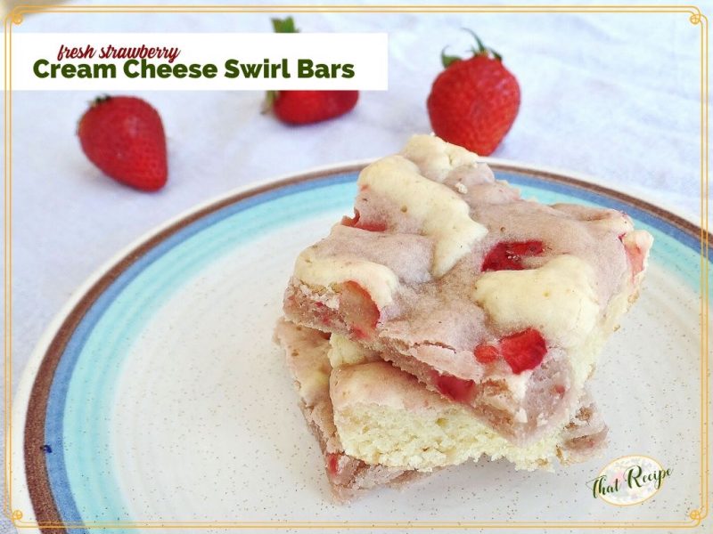 cookie bars on a plate with fresh strawberries in the background with text overlay "Fresh Strawberry Cream Cheese Swirl Bars"