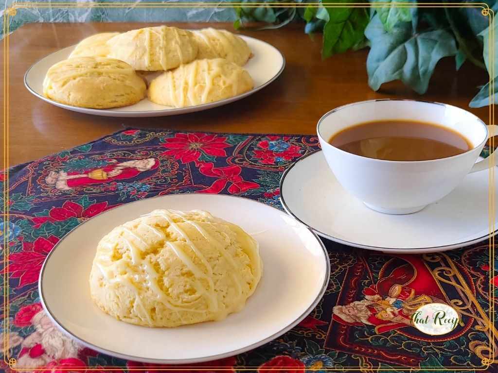 homemade eggnog scones on a plate with coffee