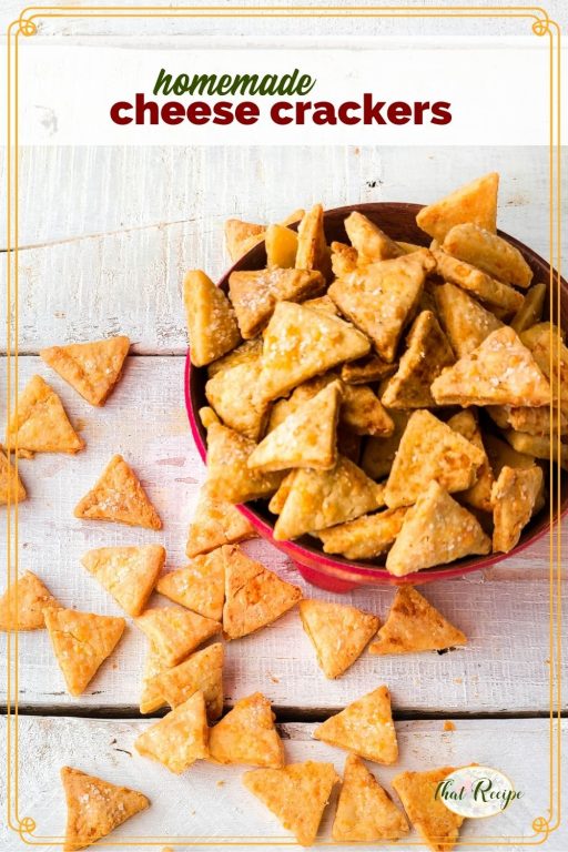 cheese crackers in a bowl and on a table with text overlay "homemade cheese crackers"