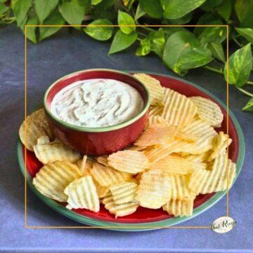 clam dip in a bowl with chips