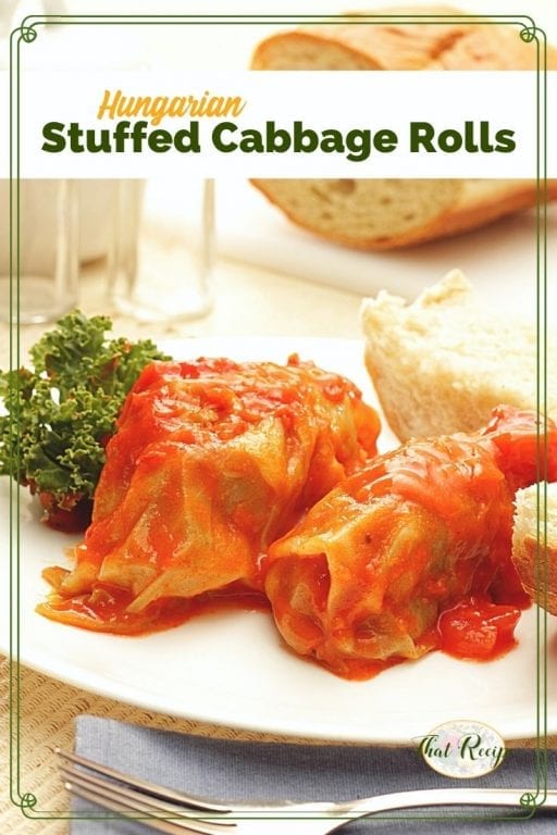 cabbage rolls on a plate with bread and text overrlay "Hungarian stuffed cabbage"