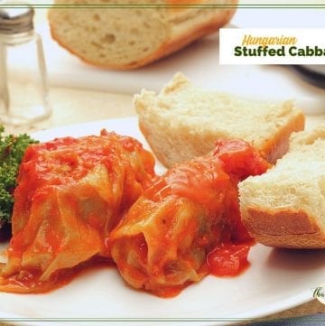 cabbage rolls on a plate with bread and text overrlay "Hungarian stuffed cabbage"