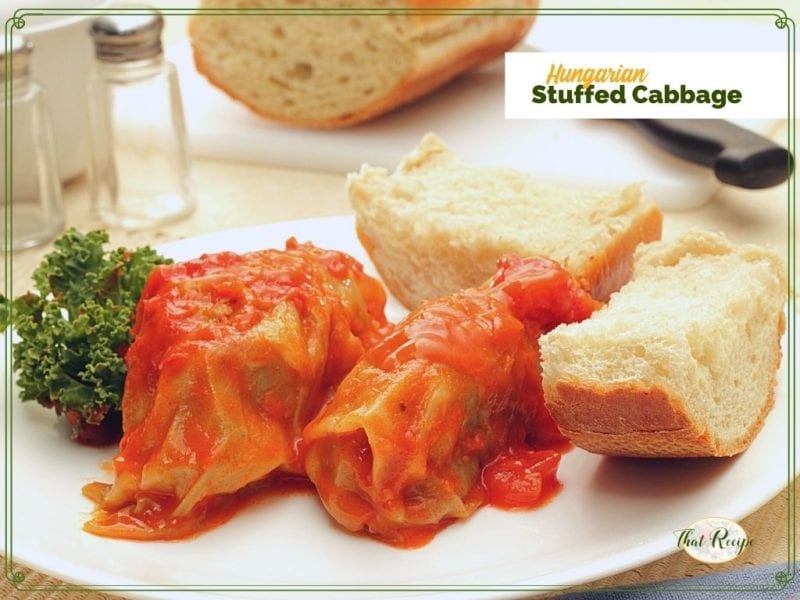 cabbage rolls on a plate with bread and text overrlay "Hungarian stuffed cabbage"