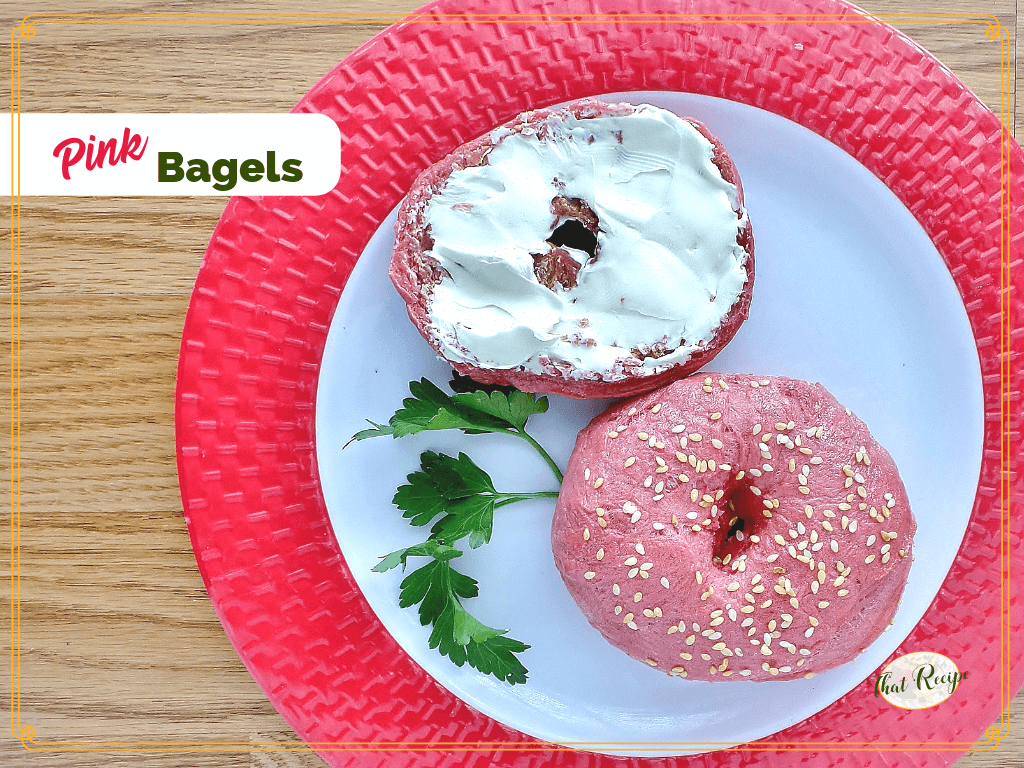 pink bagel on a plate with schmear of cream cheese