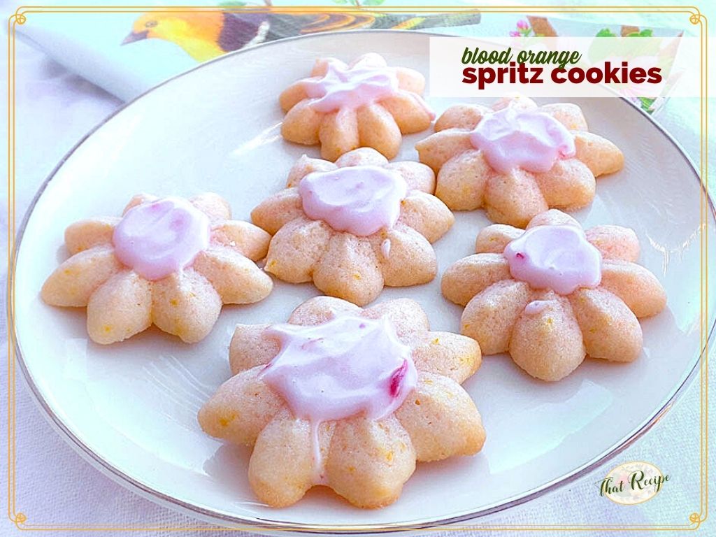 spritz cookies on a plate with text overlay "blood orange spritz cookies"