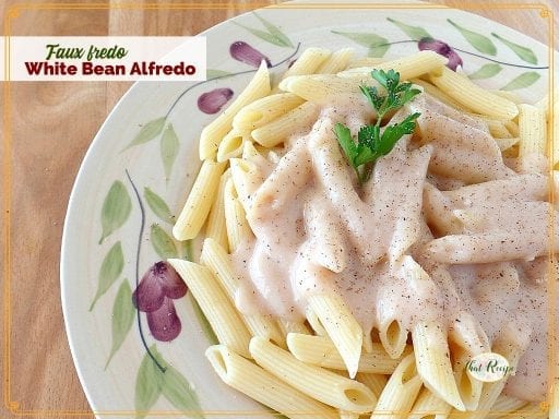 top down view of white sauce on penne noodles with text overlay Faux Fredo White Bean Alfredo"