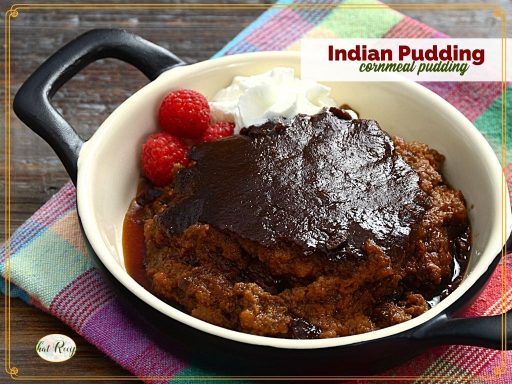 pudding in a black dish with text overlay "Indian Pudding cornmeal pudding"
