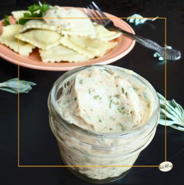 browned sage butter in a jar with a plate of pasta in background