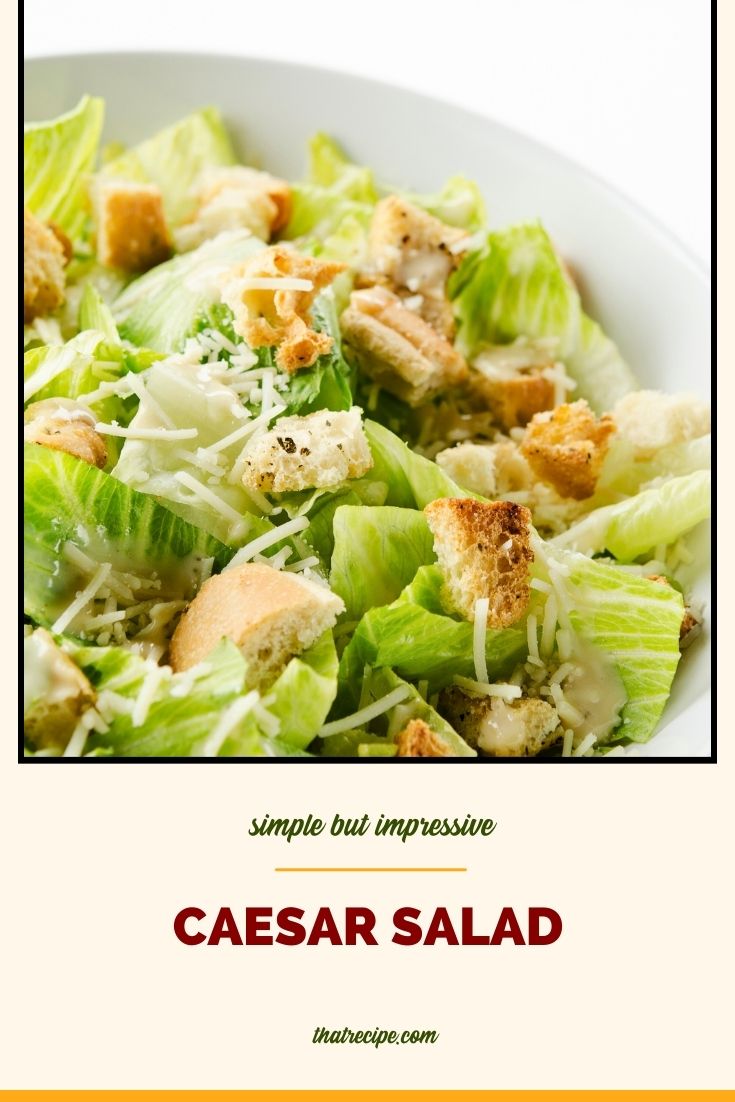 Top down view of Caesar Salad in a bowl with text overlay "Classic Caesar Salad"