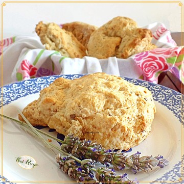 scone on a plate with fresh lavender blossoms