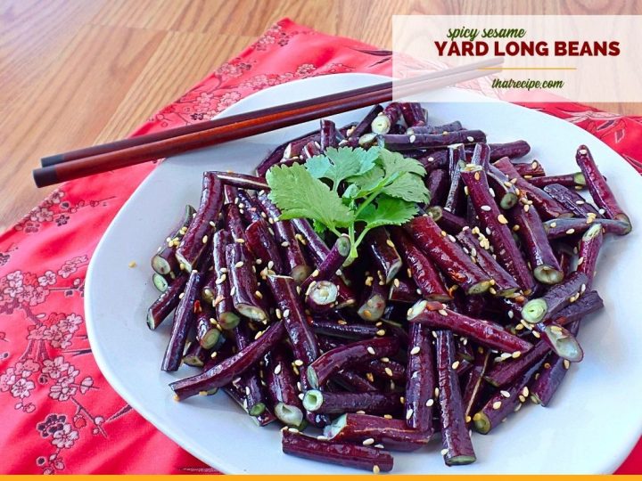 Asparagus beans on a plate with text overlay "spicy sesame yard long beans"
