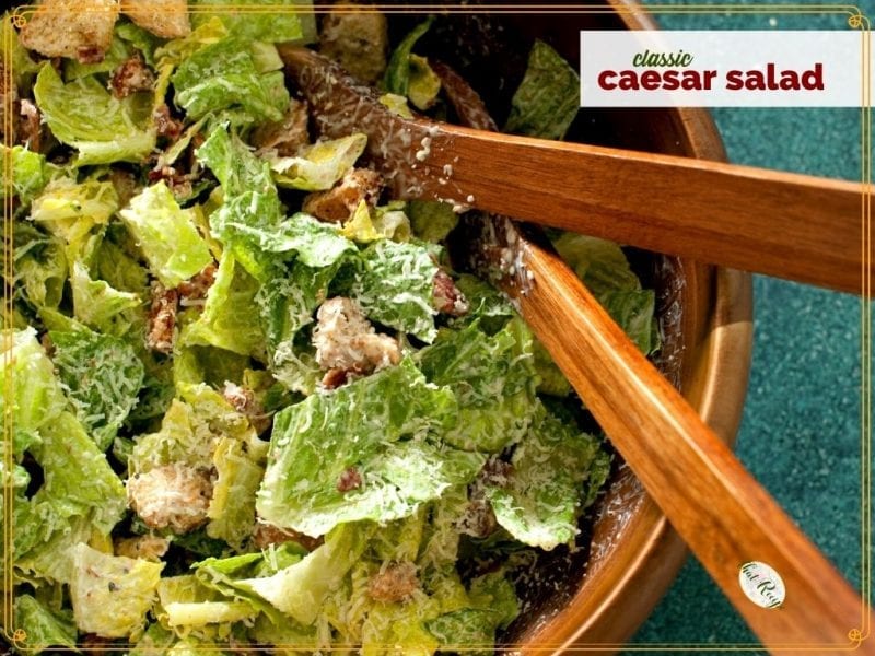 Top down view of Caesar Salad in a bowl with text overlay "Classic Caesar Salad"