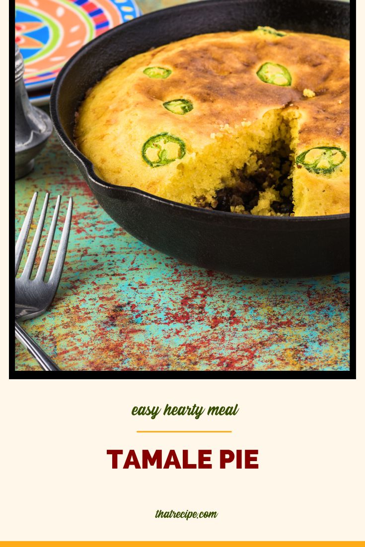 tamale pie with jalapeno pepper slices in a cast iron skillet